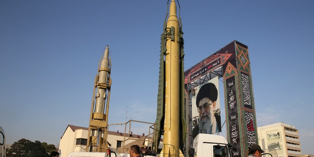 A Ghadr-H missile, center, a Sejjil missile and a portrait of the Iranian Supreme Leader Ayatollah Ali Khamenei are on display for the annual Defense Week, marking the 37th anniversary of the 1980s Iran-Iraq war, at Baharestan Sq. in Tehran, Iran, Sunday, Sept. 24, 2017