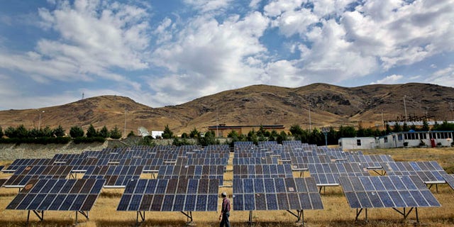 June 22, 2014: A man looks at solar panels at the Taleghan Renewable Energy Site in Taleghan, 99 miles northwest of Tehran, Iran.