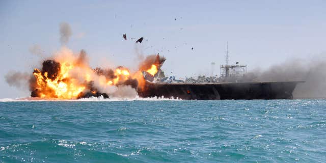 Feb. 25, 2015: A replica of a U.S. aircraft carrier is exploded by the Revolutionary Guard's speedboats during large-scale naval drills near the entrance of the Persian Gulf, Iran.