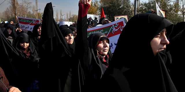 Iranian pro-government protesters chant slogans at a rally in Tehran, Iran, Saturday.