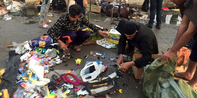 Feb. 28, 2016: Street vendors collect their belongings after deadly bombing attacks in Sadr City, Baghdad, Iraq.