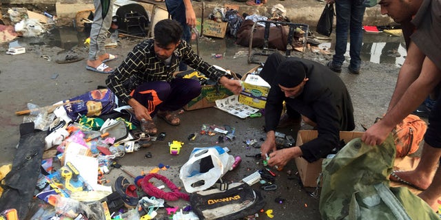 Feb. 28, 2016: Street vendors collect their belongings after deadly bombing attacks in Sadr City, Baghdad, Iraq.