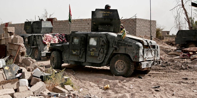 June 8, 2016: Humvees stage on the the edge of the Shuhada neighborhood in Islamic State-held Fallujah, Iraq, just before Iraqi special forces pushed into the district.