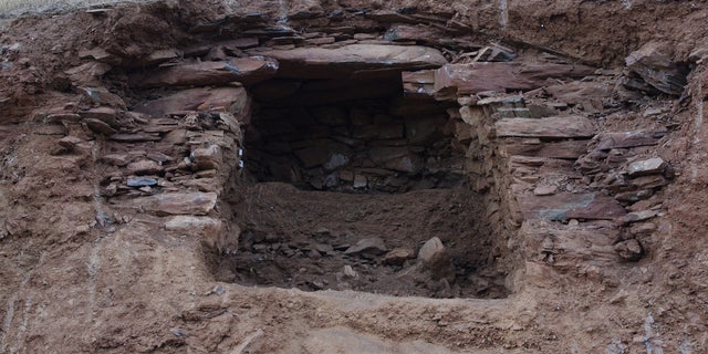 A tomb in northern Iraq held a pile of skeletons, including those dating back 2,400 years and more recent burials (shown here). The white dust is from the excavation of the more recent burials.
