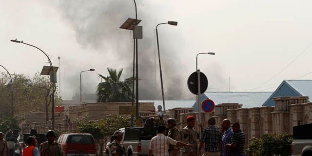March 14, 2013: Members of the Iraqi Army gather near the site of a bomb attack at Alawi district in Baghdad. Co-ordinated blasts in the heart of the Iraqi capital Baghdad killed at least 22 people on Thursday, near the heavily fortified Green Zone, where several Western embassies are located, police and medics said.