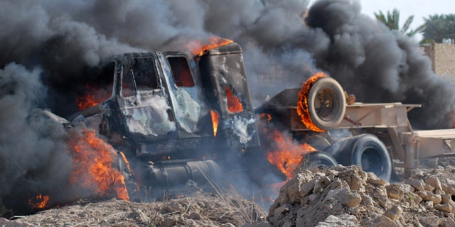 April 23, 2013: A burning Iraqi army military vehicle near the demonstration site in Ramadi, Iraq, 70 miles west of Baghdad, Iraq. Protesters threw stones on a military convoy that was passing near the protest site in Ramadi, one army Humvee was flipped over and the soldiers opened fire on the fire, then they left, the protesters set fire on the abandoned army vehicle. Iraqi security forces backed by helicopters raided a Sunni protest camp before dawn Tuesday, prompting clashes that killed at least 36 people in the area and significantly intensified Sunni anger against the Shiite-led government.