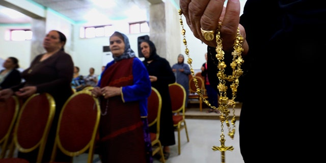 July 19, 2014: In this photo, displaced Christians who fled the violence in Mosul, pray at Mar Aframa church in the town of Qaraqoush on the outskirts of Mosul, Iraq. (AP)