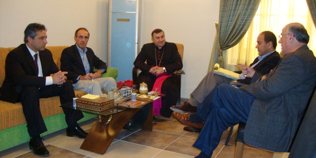 DeKelaita, (l.), in a meeting with Archbishop of Erbil Bashar Matte Warda, (c.), to discuss the plight of Iraq's Christian community.