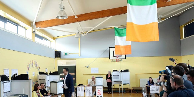 Ireland's Prime Minister Leo Varadkar cast his vote at the polling station as the country goes to the polls to vote in the referendum on the 8th Amendment of the Irish Constitution, in Dublin, Friday, May 25, 2018. Voters throughout Ireland have begun casting votes in a referendum that may lead to a loosening of the country's strict ban on most abortions. (Niall Carson/PA via AP)