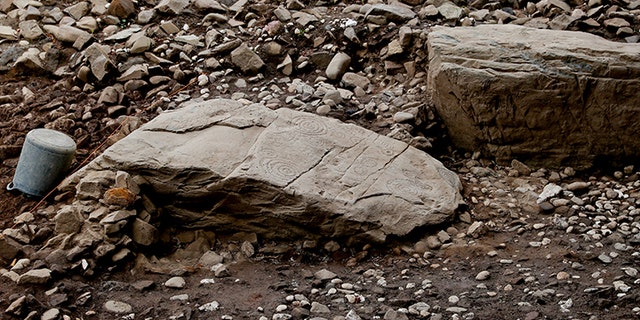 A kerbstone with elaborate carvings.