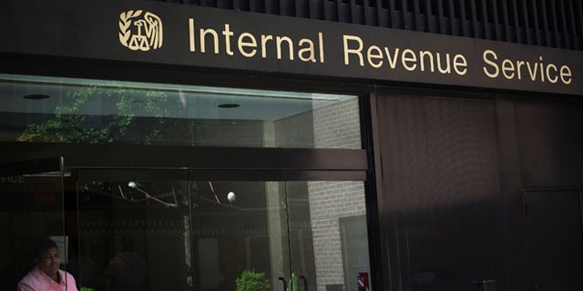 May 13, 2013: A woman walks out of the Internal Revenue Service building in New York.
