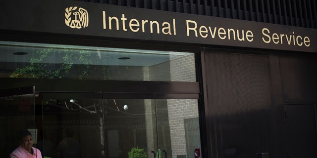 May 13, 2013: A woman walks out of the Internal Revenue Service building in New York in this photo.