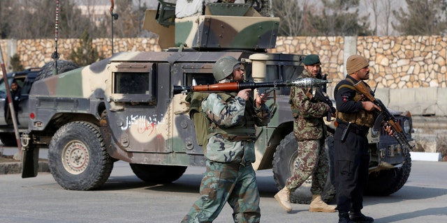 Afghan security forces keep watch at the site of an attack in Kabul, Afghanistan December 18, 2017.