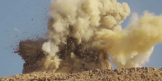 This undated photo released on June 22, 2015, by a militant website, which has been verified and is consistent with other AP reporting, shows one of two mausoleums blowing up by the Islamic State militants, in the historic central town of Palmyra, Syria.