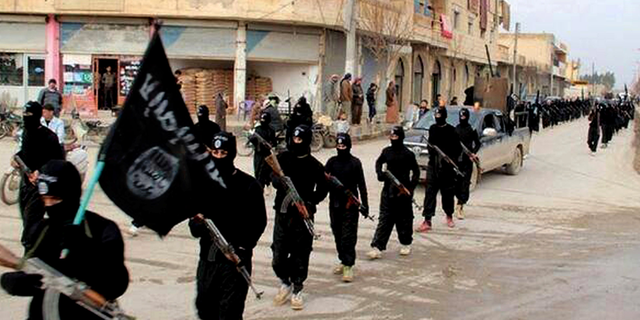 ISIS militants marching in Raqqa, Syria.