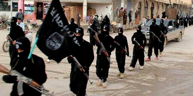 Jan. 14, 2014: This undated file image posted on a militant website on shows fighters from the al-Qaida-linked Islamic State of Iraq and the Levant (ISIS) marching in Raqqa, Syria.