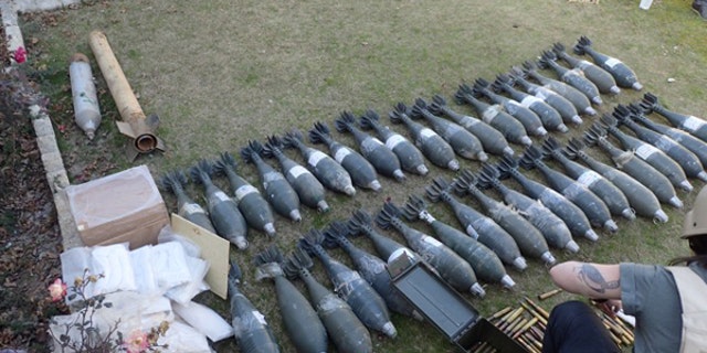 Morrow inspects ammunition and mortars captured from ISIS during the Mosul offensive.