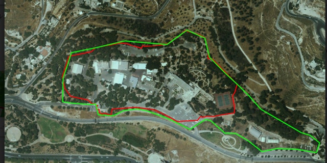 An aerial view of the U.N. compound as it looks today. The green line is the current compound, the red line marks the original dimensions allotted by the Israeli government for use by the U.N. It has constructed additional buildings, a gas station, storage facilities, and more: all without building permits or oversight of any kind. (Regavim)