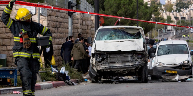 Nov. 5, 2014: An Israeli fire fighter walks at the scene of an attack in Jerusalem. A Palestinian man rammed his car into a crowded train platform in east Jerusalem on Wednesday and then attacked people with an iron bar, killing one person and injuring 13 in what authorities called a terror attack before he was shot dead by the police. The militant Islamic group Hamas took responsibility for the attack.