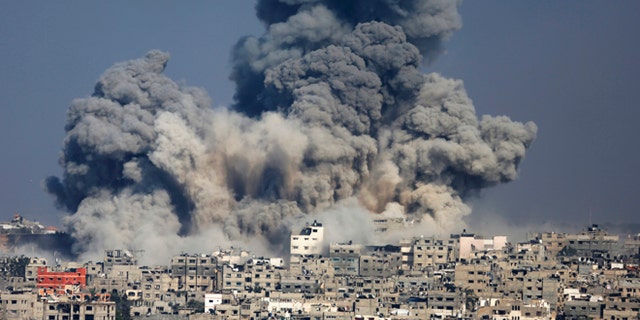 July 29, 2014: Smoke from the explosion of an Israeli strike rise over Gaza City. Israel escalated its military campaign against Hamas on Tuesday, striking symbols of the group's control in Gaza and firing tank shells that shut down the strip's only power plant in the heaviest bombardment in the fighting so far.