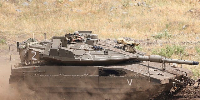 May 10, 2018: An Israeli Tank drives in the Israeli-controlled Golan Heights, near the border with Syria.