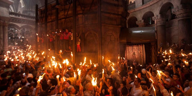 Apr. 19, 2014: Christian pilgrims hold candles at the church of the Holy Sepulcher, traditionally believed to be the burial site of Jesus Christ, during the ceremony of the Holy Fire in Jerusalem's Old City.
