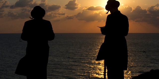 Oct. 2, 2014: Ultra-Orthodox Jews of the Hassidic sect Vizhnitz gather on a hill overlooking the Mediterranean sea as they participate in a Tashlich ceremony in Herzeliya, Israel. (AP)