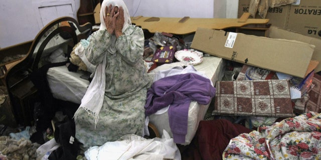 June 22, 2014: A Palestinian woman cries in her home after a raid by Israeli troops as the army continues feverish searches for three missing Israeli teens, in Salim village near the West Bank city of Nablus. (AP)