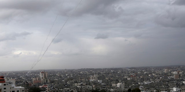 Mar. 12, 2014: A trail of smoke from rockets fired by Palestinian militants from Gaza toward Israel is seen above Gaza City.