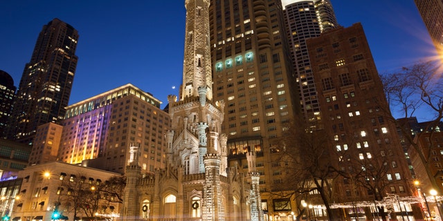 Image of Chicago Water Tower and Michigan Avenue during twilight blue hour.