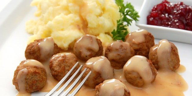 "Swedish meatballs served with the traditional accompaniments of gravy, mashed potatoes, and lingonberry sauce.More images from this series:"