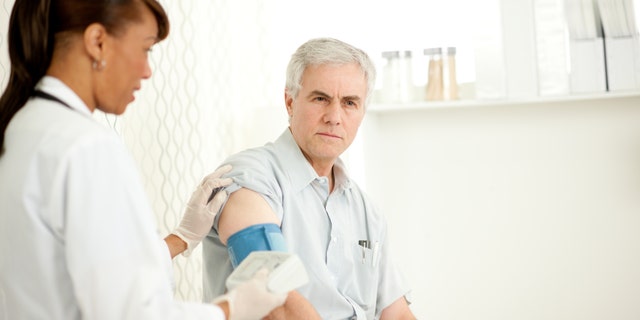 A female doctor or nurse with a patient
