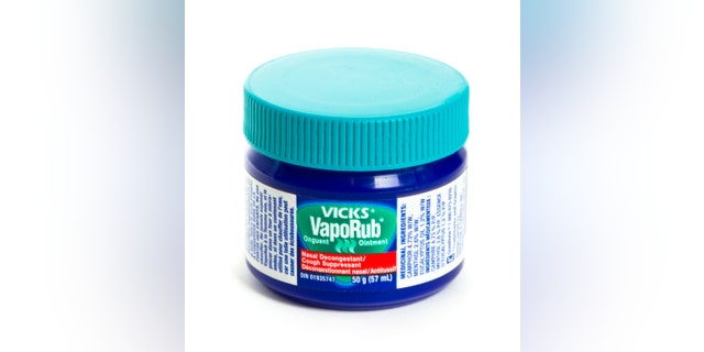 "Chatham, Ontario, Canada - February 17, 2011: An isolated 50 g jar of Vick's VapoRub which is a product of Procter & gamble inc. Vick's VapoRub is commonly used for the relief of nasal congestion and muscle aches due to cold."