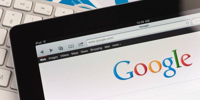 Sydney, Australia - September 6, 2011: Close up of an Apple Ipad and on a desk showing the Google search engine home screen. There is also a keyboard and some documents on the desk, the documents show charts and graphs. This scene depicts ipad in a working environment.