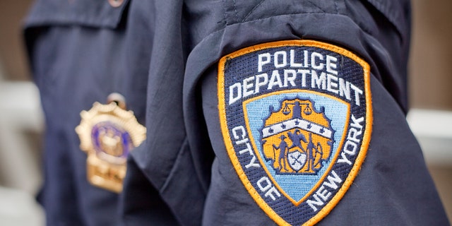 A New York City police logo is seen on an officer's uniform.