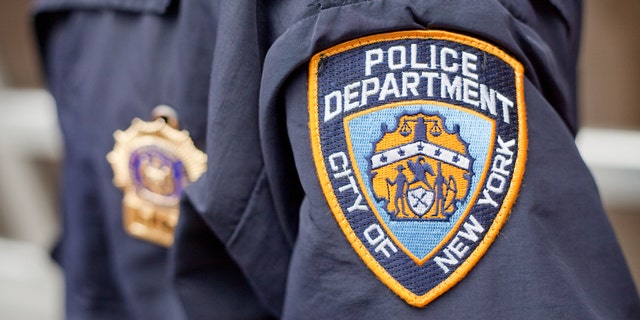 A New York City police logo is seen on an officer's uniform.
