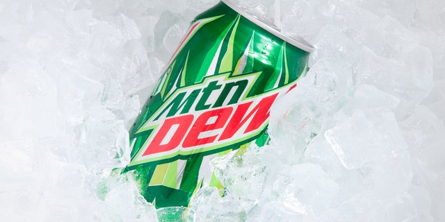 A can of Mountain Dew buried in ice cubes. A Pennsylvania man is charged with a felony for underpaying for a Mountain Dew bottle by less than 50 cents.