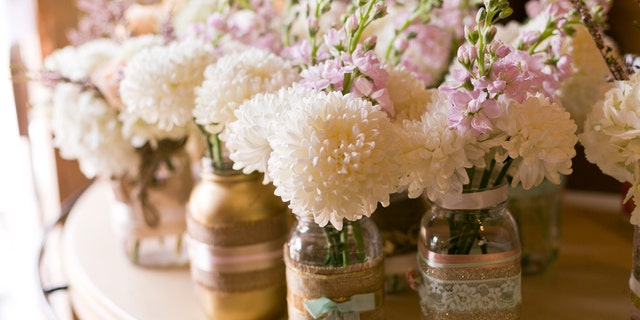 DIY flower arrangements like simple mason jars or even flowerless centerpieces will be way cheaper than a florist.