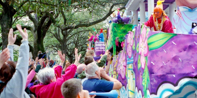 Mardi Gras Parade on St. Charles Ave - New Orleans. The crowd yells "throw me something mister" at the Krewe.