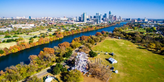 Changing Colors Along Colorado River Aerial Shot Flying over Zilker Park in Austin , Texas with the trail of lights display ready for Christmas. December brings changing of seasons and the dropping of leaves in Central Texas
