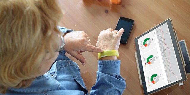 Senior woman using health technology