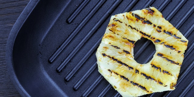 Fried pineapple on the grill. Preparing sandwich