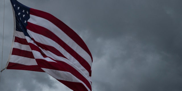 American Flag blowing in the wind of an approaching storm
