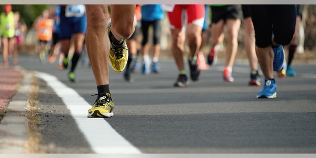 A teenager helped a marathon runner cross the finish line after her legs gave out.