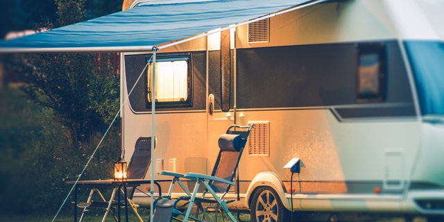 Travel Trailer Caravaning. RV Park Camping at Night.