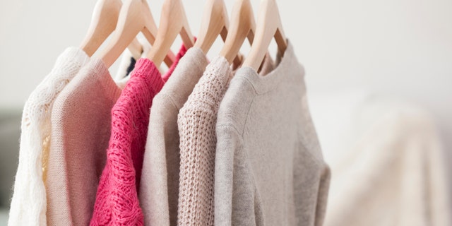 Colorful sweater hanging on wooden hanger