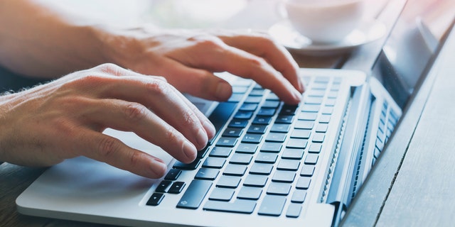 close up of hands of business person working on computer, man using internet and social media
