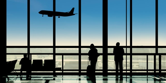 Waiting in the airport terminal watching planes