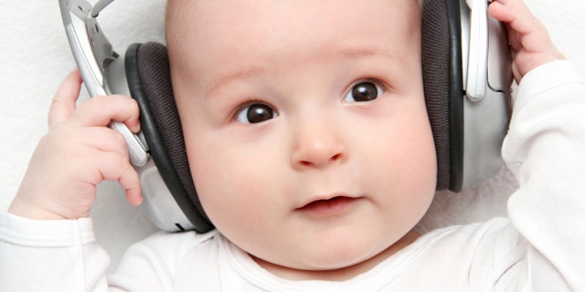 baby listening music on back