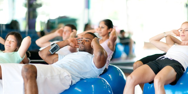 Diverse group of people in gym doing exercise